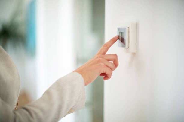 Hand switching lights on Hand on light switch with index finger energy efficient stock pictures, royalty-free photos & images