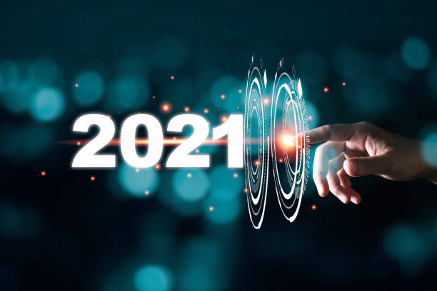 Hand touching pass thru infographic to 2021 year with blue bokeh and dark background. New year change concept.  2021 stock pictures, royalty-free photos & images