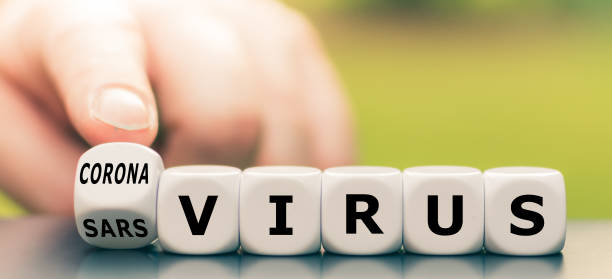Hand turns a dice and changes the expression "sars virus" to "corona virus". Hand turns a dice and changes the expression "sars virus" to "corona virus". severe acute respiratory syndrome photos stock pictures, royalty-free photos & images
