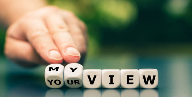 Hand turns dice and changes the expression "your view" to "my view". stock photo