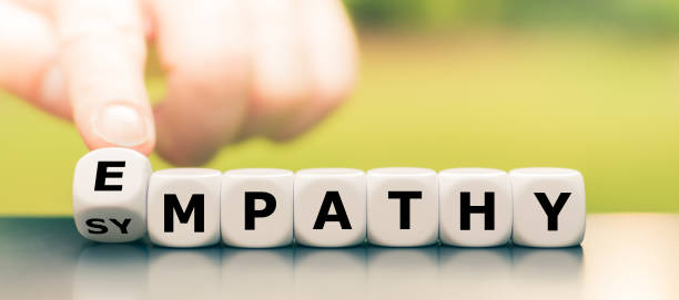 Hand turns dice and changes the word "sympathy" to "empathy". stock photo