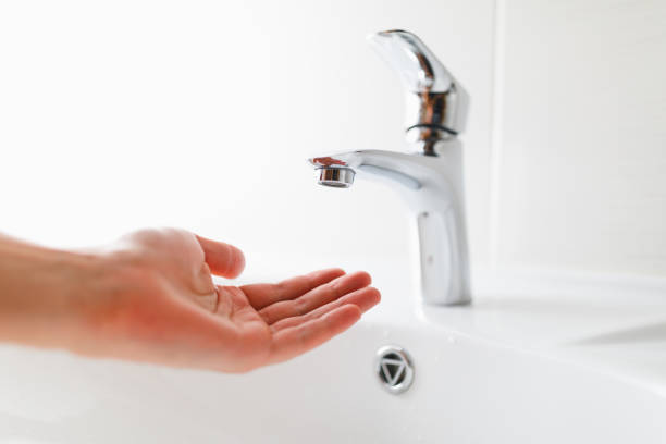hand under faucet without water hand under faucet without water, close-up view low stock pictures, royalty-free photos & images