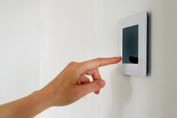 Hand using Air ventilation controller with display Hand using Air ventilation controller panel with display at home. Smart house system smart thermostat stock pictures, royalty-free photos & images