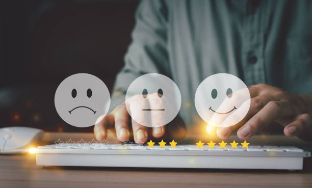 Hand using keyboard with Happy icon and Five stars for service rating feedback of experience customer survey. Business annual satisfaction  concept. Many sad or happily icons, excellent performance. stock photo