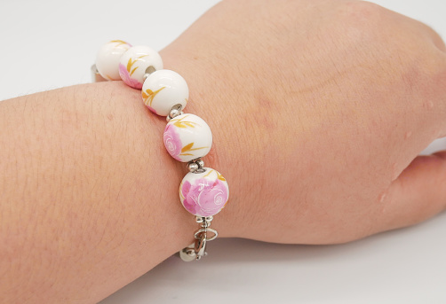 Hand wearing ceramic beads bracelet