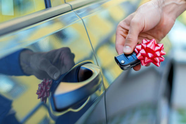 Hand with car's key as a gift of car stock photo