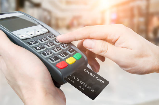 Hand with credit card swipe through terminal for sale in superma Hand with credit card swipe through terminal for sale in supermarket credit card reader stock pictures, royalty-free photos & images
