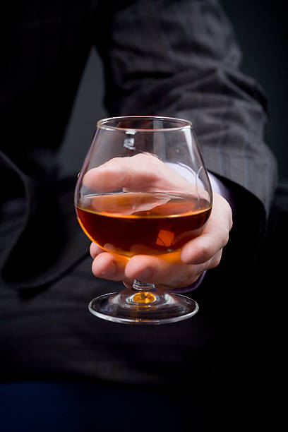 Hand with glass of cognac stock photo