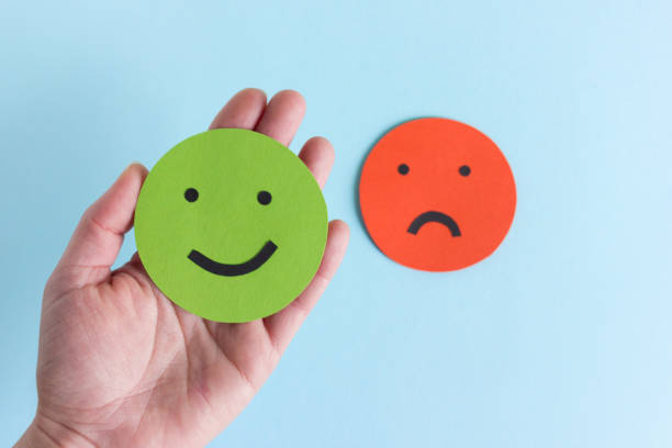 Hand with smileys for giving opinion stock photo