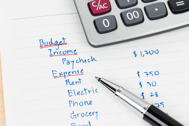 Hand writing home budget with calculator Hand writing home budget with calculator monthly event stock pictures, royalty-free photos & images