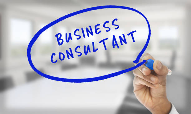 Hand writingBusiness Consultant with blue pencil stock photo