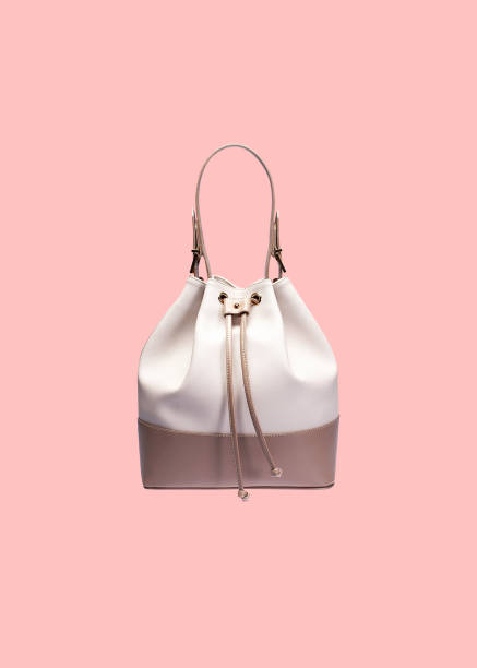 Handbag isolated on pink background Two-tone bucket bag isolated on a pink background with clipping path womenswear stock pictures, royalty-free photos & images