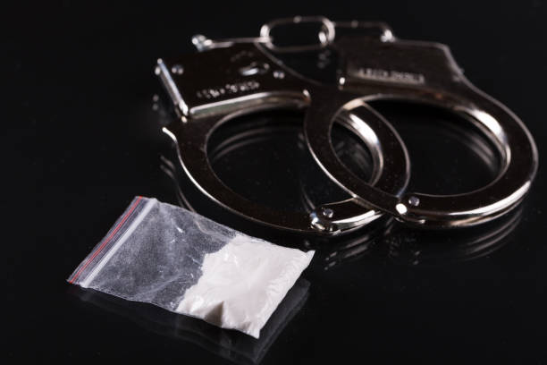 Handcuffs and cocaine stock photo