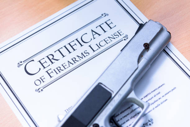 Handgun laying on a Gun / Firearms License Certificate Handgun laying on a Gun / Firearms License Certificate weapon stock pictures, royalty-free photos & images