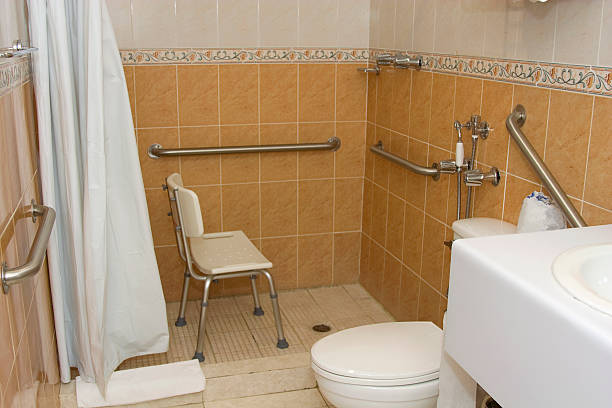 Handicap accessible shower with grab bars and a chair stock photo