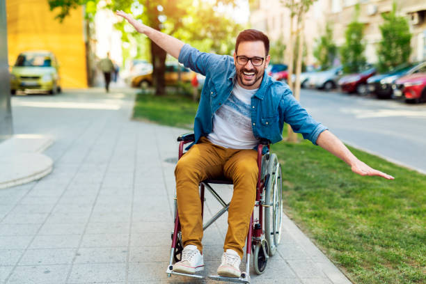 handicapped man in a wheelchair - wheelchair street happy imagens e fotografias de stock