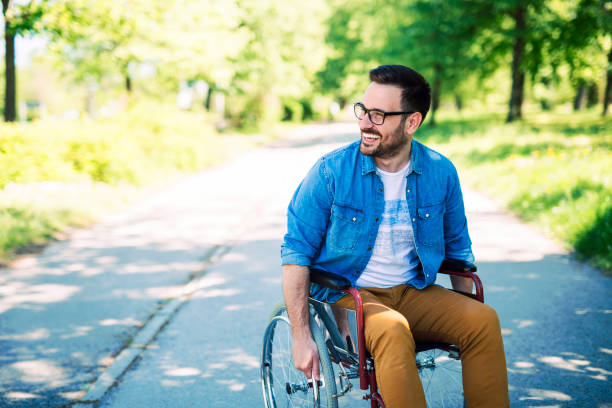 handicapped man on street - wheelchair street happy imagens e fotografias de stock