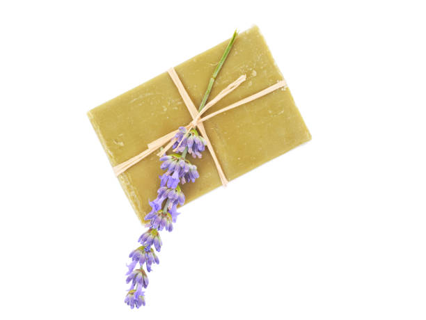 Handmade olive soap and lavender flower isolated on white background. Top view. stock photo