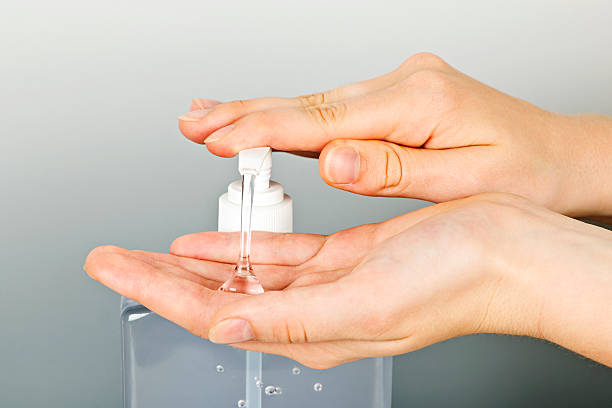 Hands applying germ sanitizer gel stock photo