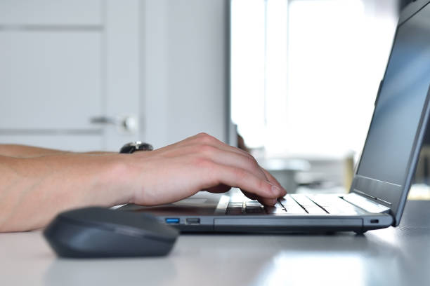 Hands businessman typing on laptop keyboard in office. stock photo