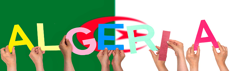 hands forming Algeria text with flag background