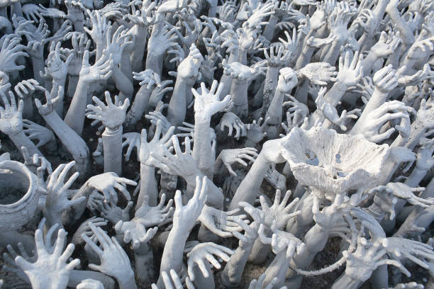 Hands from hell - exterior details of  Wat Rong Khun, White Temple in Chiang Rai Province, Northern Thailand stock photo