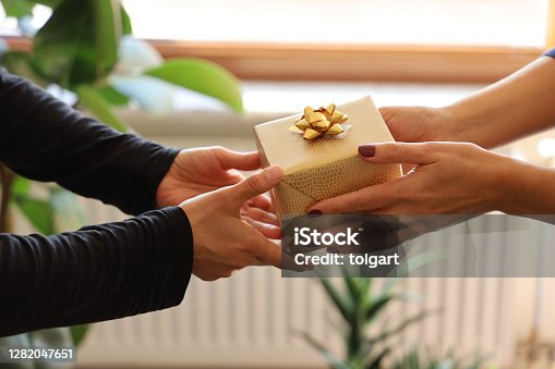 istock Hands Giving Gift Close-up 1282047651