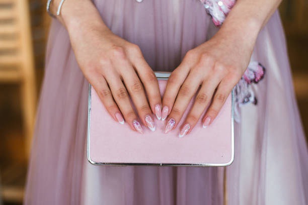 hands holding a pink clutch hands of a girl holding her glitter pink clutch evening gown stock pictures, royalty-free photos & images