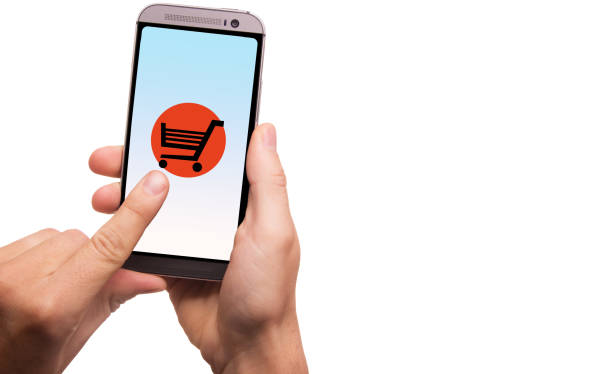 Hands holding a smartphone with cart button on touch screen stock photo