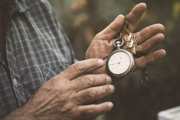 Hands holding a vintage pocket watch stock photo