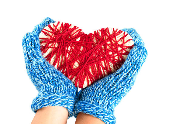 Hands holding a woven heart stock photo