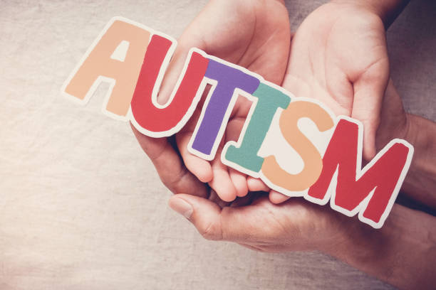Hands holding AUTISM word,  mental health concept, world autism awareness day Hands holding AUTISM word,  mental health concept, world autism awareness day autism stock pictures, royalty-free photos & images