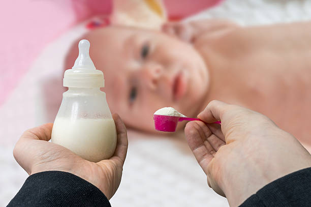 hands holds bottle with milk formula prepaired for feeding baby. - baby formula stok fotoğraflar ve resimler