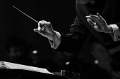 istock Hands of a conductor of a symphony orchestra close-up 1299364271