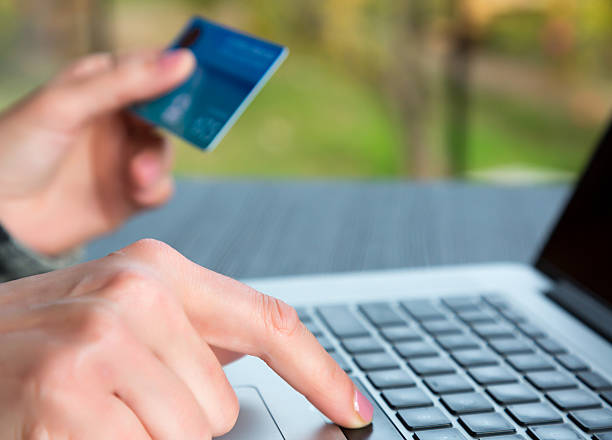 Hands of person entering credit Card Data on Laptop stock photo