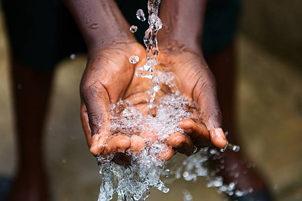 Hands of poor child - scoop drinking water, Africa stock photo