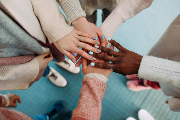 Hands of women of different races touch each other closeup. Hands of women of different races touch each other closeup. The concept of friendship and unity between different human races. female friendship stock pictures, royalty-free photos & images