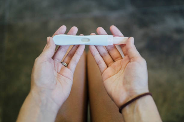 Hands of young girl holding a pregnancy test stock photo