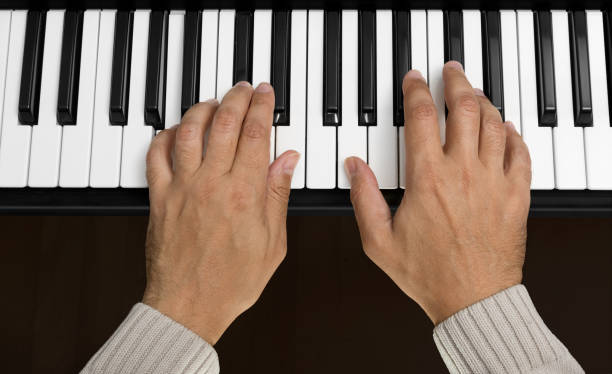 Hands on Piano Keyboard stock photo