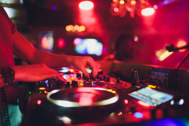 DJ hands on the remote. nightclub. DJ controlling and moving the mixers in music remote. stock photo