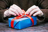istock Hands packing gift box 636054716