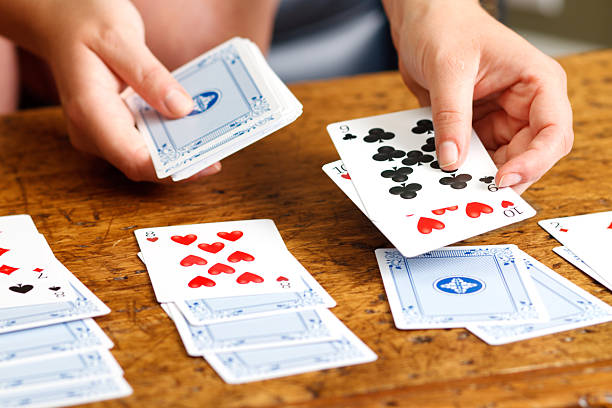 Hands Playing Solitaire Card Game stock photo