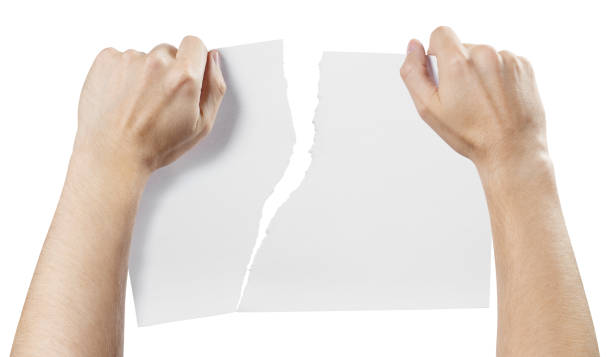 Hands tearing a piece of paper on white Hands tearing a piece of paper, isolated on white background rule breaker stock pictures, royalty-free photos & images