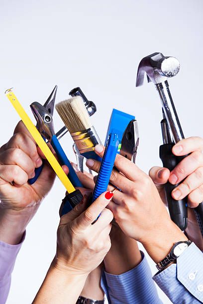 Hands with construction tools stock photo