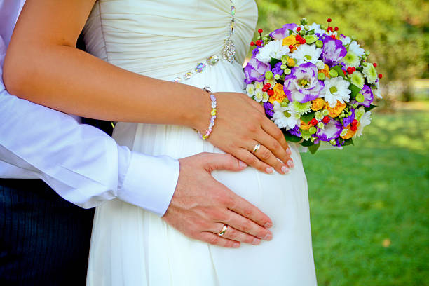 hands with rings and bouquet stock photo