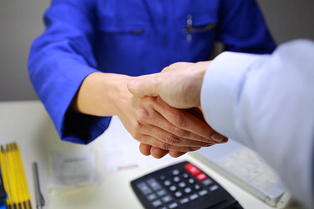 handshake between a workshop manager and a client stock photo