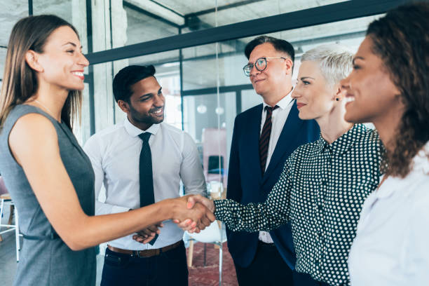 Handshake of business People Business people shaking hands at the office coalition stock pictures, royalty-free photos & images