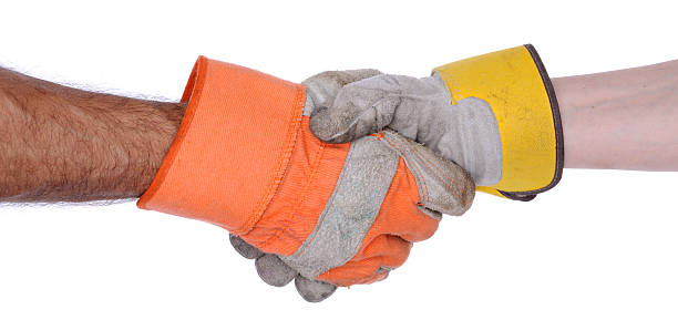 Handshake with Two Hands Wearing Work Gloves stock photo