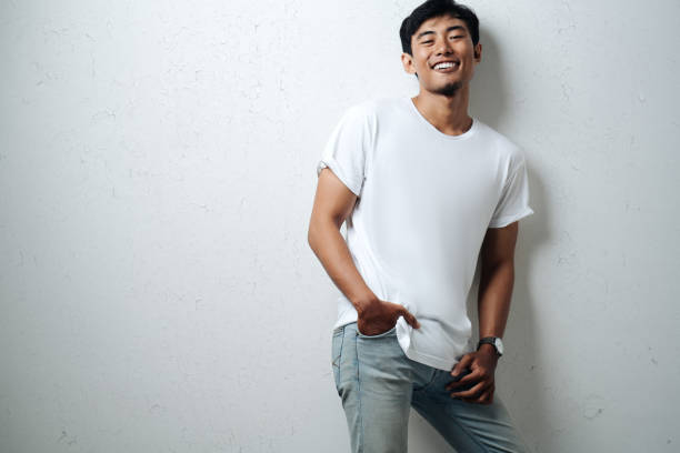 Handsome asian man in white blank t-shirt stock photo