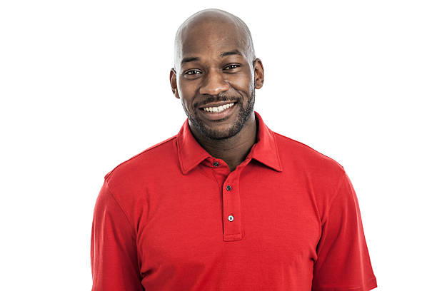 Handsome black man wearing a red shirt smiling into camera stock photo